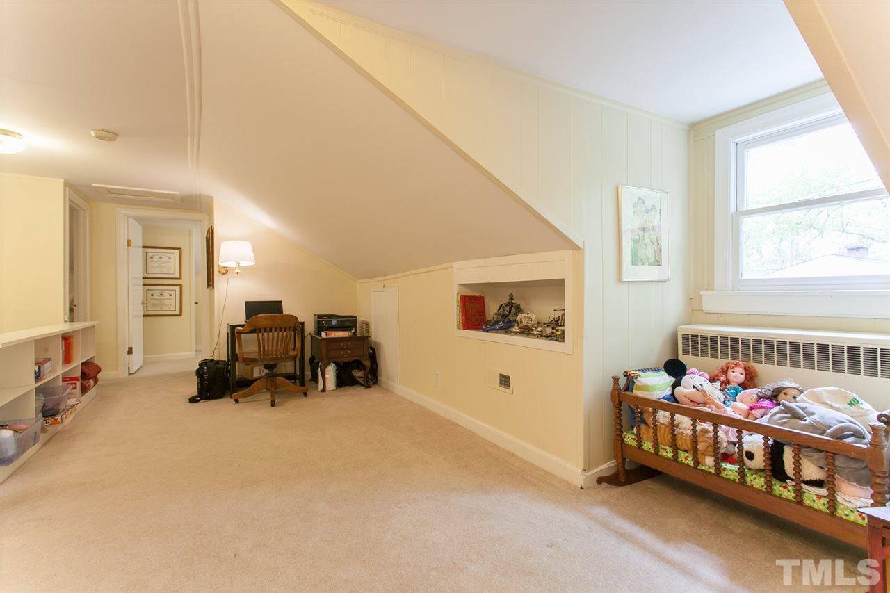 2509 Pickett Road Durham, NC 27705 - Photo 17 of 25 a bedroom with furniture and a window