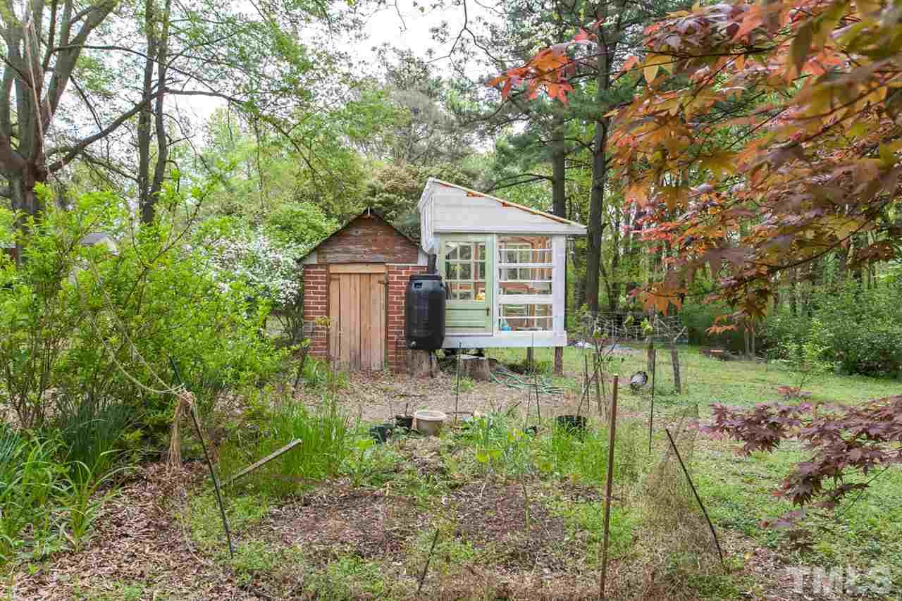 2509 Pickett Road Durham, NC 27705 - Photo 23 of 25 a backyard of a house with plants and large tree