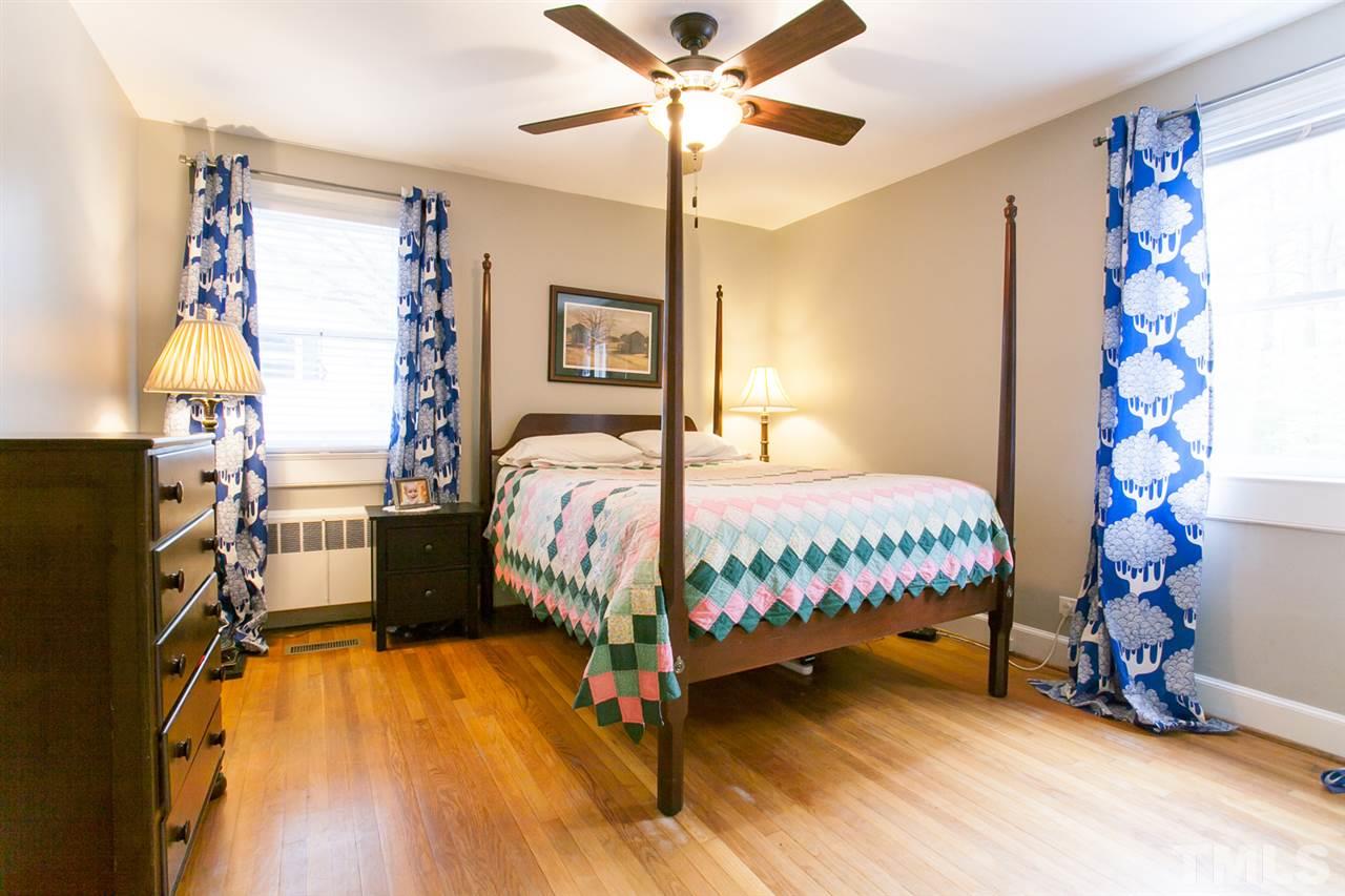 2509 Pickett Road Durham, NC 27705 - Photo 9 of 25 a bedroom with a bed and a chandelier