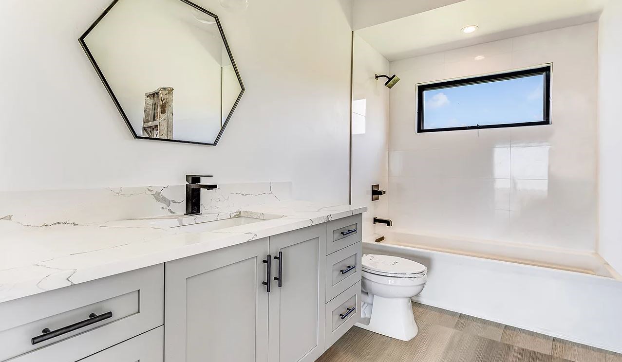 804 Anapuni Loop, Unit 63 Lahaina, HI 96761 - Photo 18 of 30 a bathroom with a toilet sink and mirror