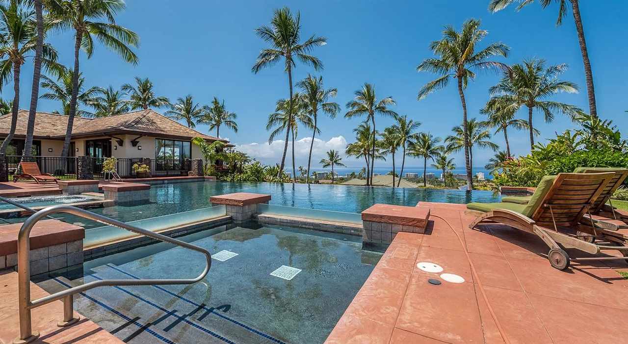 804 Anapuni Loop, Unit 63 Lahaina, HI 96761 - Photo 29 of 30 a patio table and chairs with potted plants and palm trees