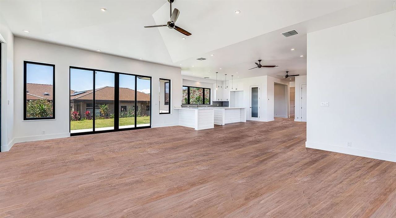 804 Anapuni Loop, Unit 63 Lahaina, HI 96761 - Photo 3 of 30 a view of empty room with wooden floor and fan