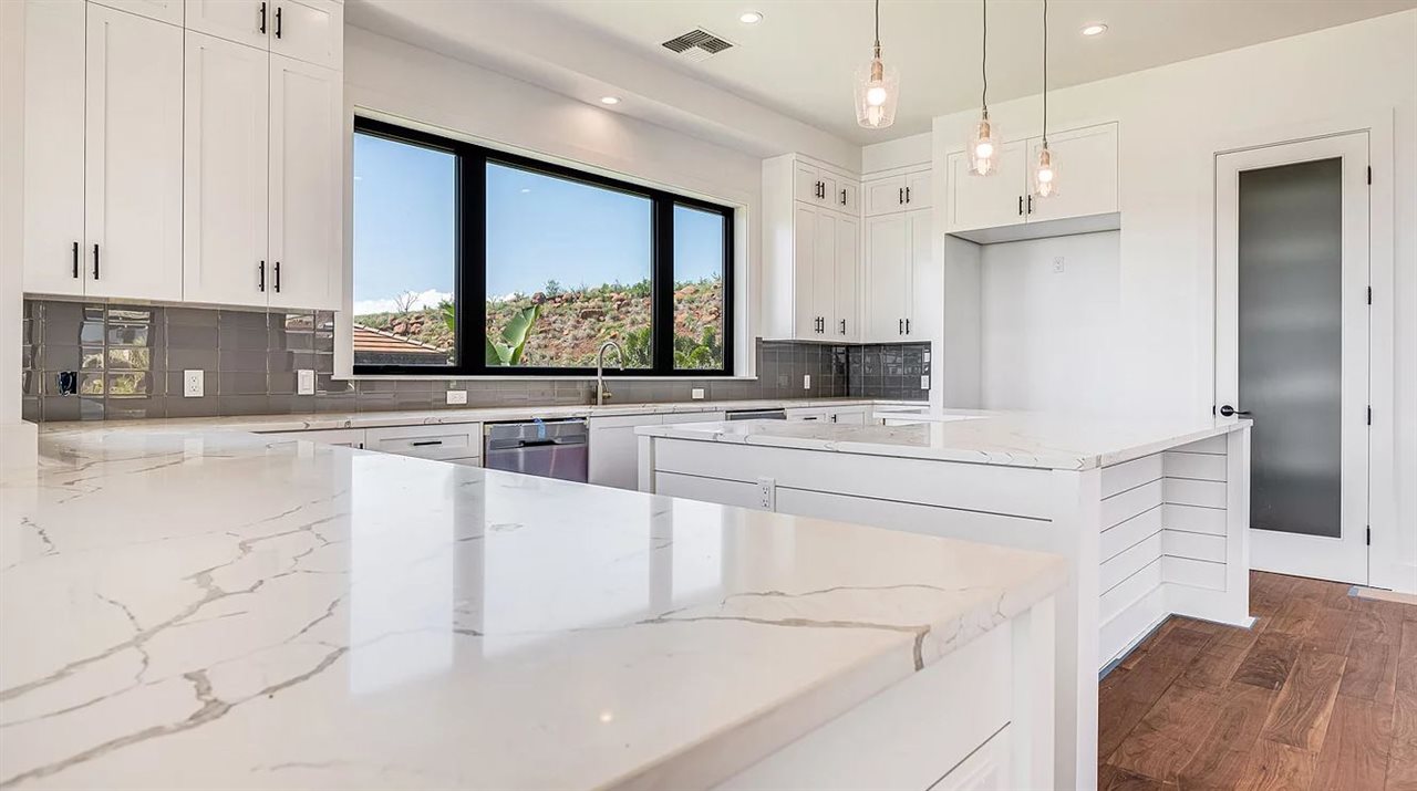 804 Anapuni Loop, Unit 63 Lahaina, HI 96761 - Photo 7 of 30 a kitchen with stainless steel appliances kitchen island granite countertop a stove a sink and a refrigerator