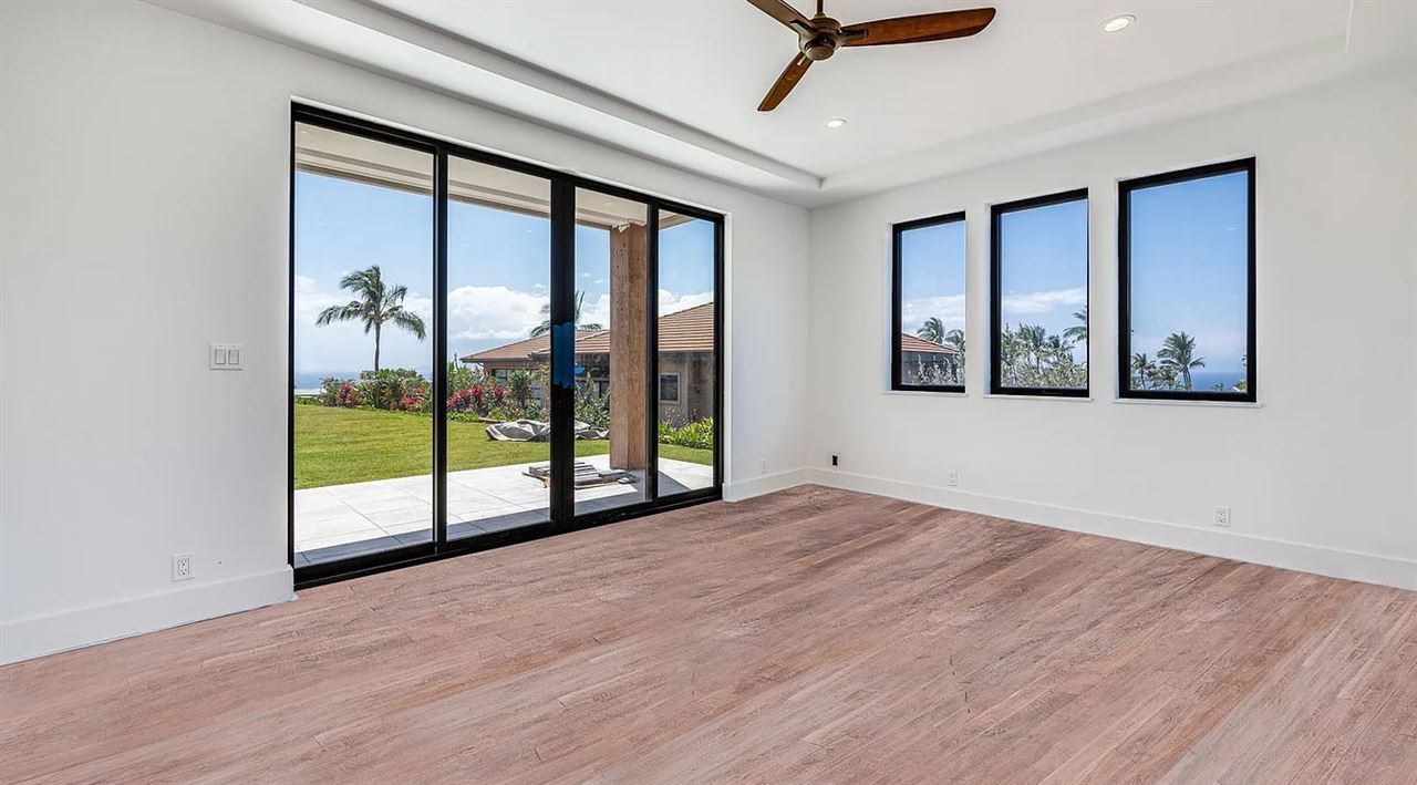 804 Anapuni Loop, Unit 63 Lahaina, HI 96761 - Photo 9 of 30 a view of an empty room with wooden floor and a window