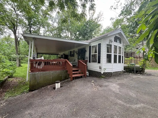 a front view of a house with a garden and outdoor seating