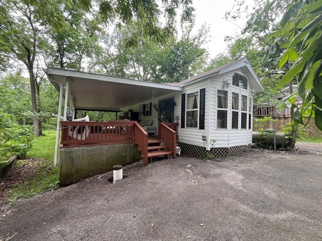 a front view of a house with a garden and outdoor seating