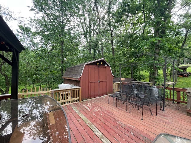2795 East 28th Road Marseilles, IL 61341 - Photo 19 of 64 a view of a roof deck with table and chairs and wooden floor