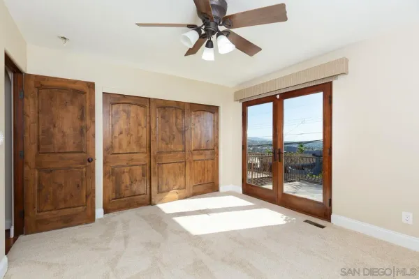 a view of a room with cabinet and a ceiling fan