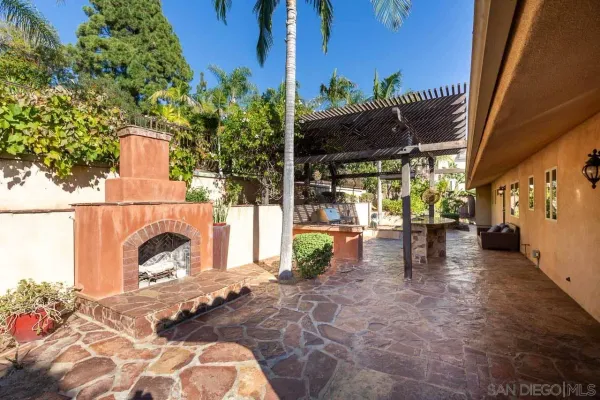 a view of a patio with table and chairs and potted plants