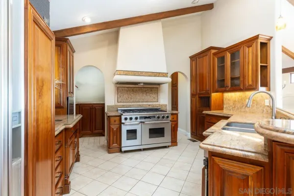 a kitchen with stainless steel appliances granite countertop a stove and a refrigerator