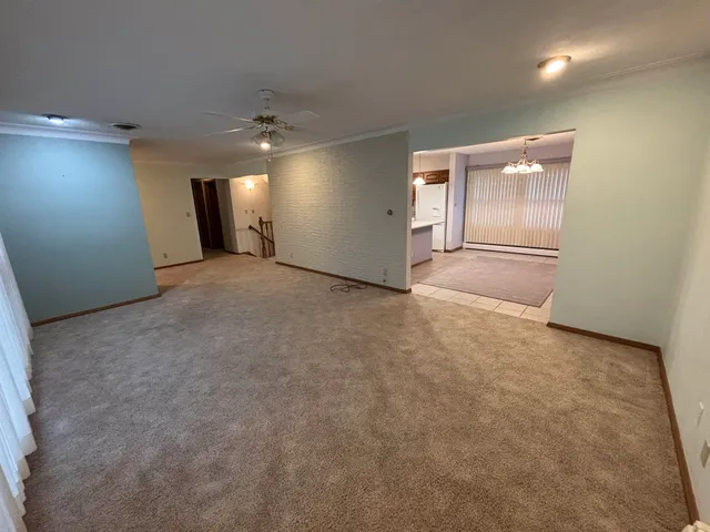 en empty room with windows and cabinet