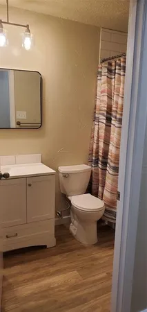 a bathroom with a toilet and a shower