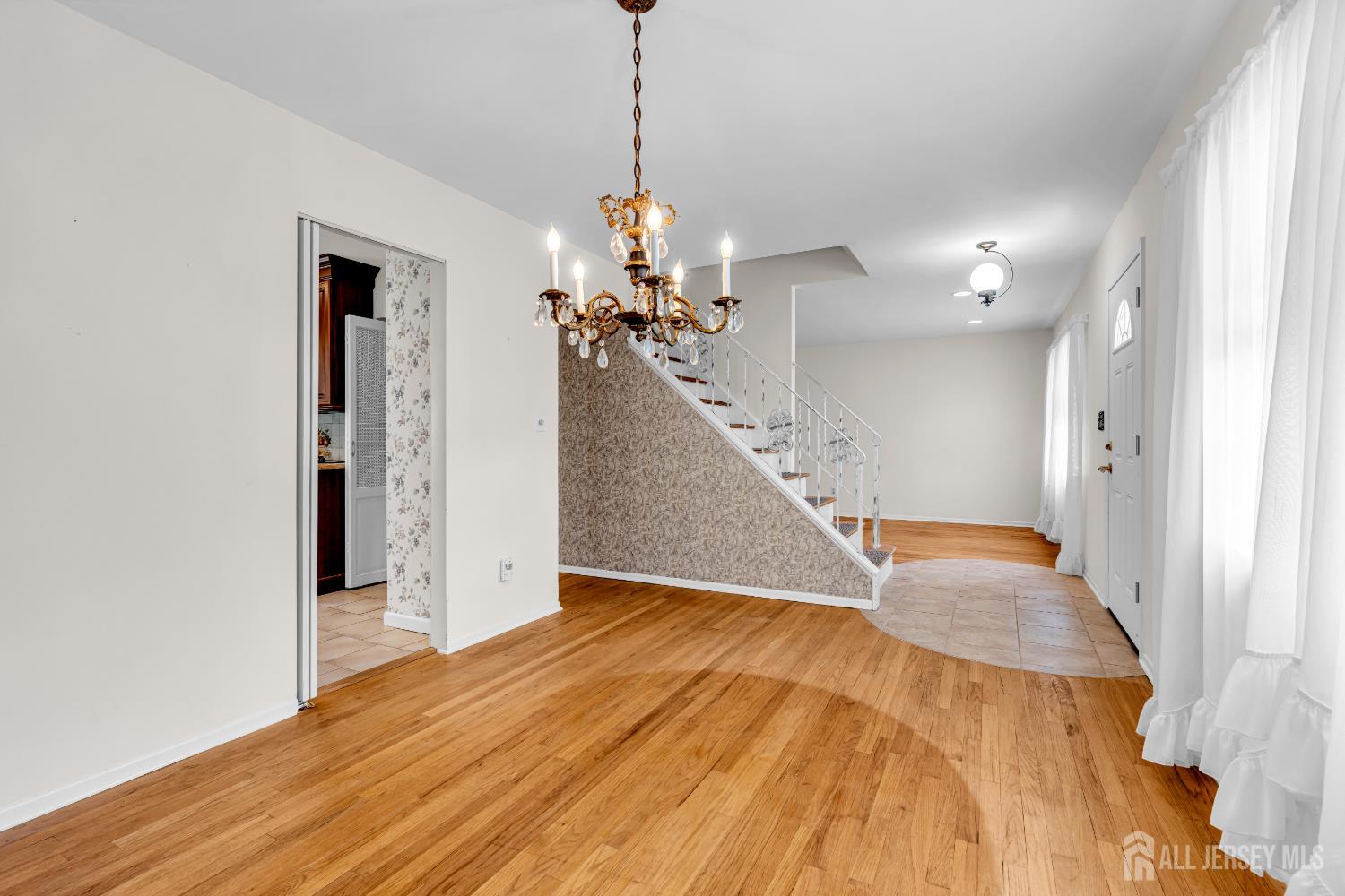 30 Daniel Drive Matawan, NJ 07747 - Photo 10 of 49 a view of a livingroom with wooden floor and a ceiling fan