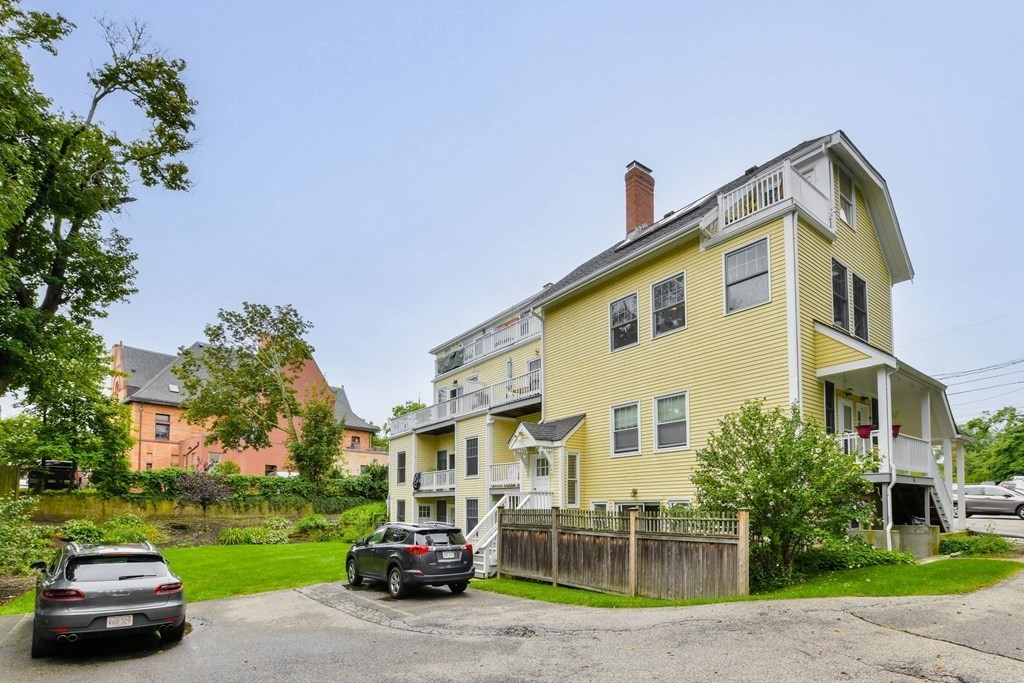 110 Maple Place, Unit 8 Dedham, MA 02026 - Photo 19 of 22 a view of a car parked in front of a house