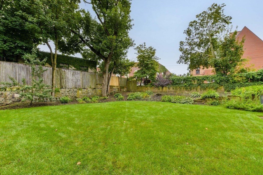 110 Maple Place, Unit 8 Dedham, MA 02026 - Photo 20 of 22 a view of backyard with green space
