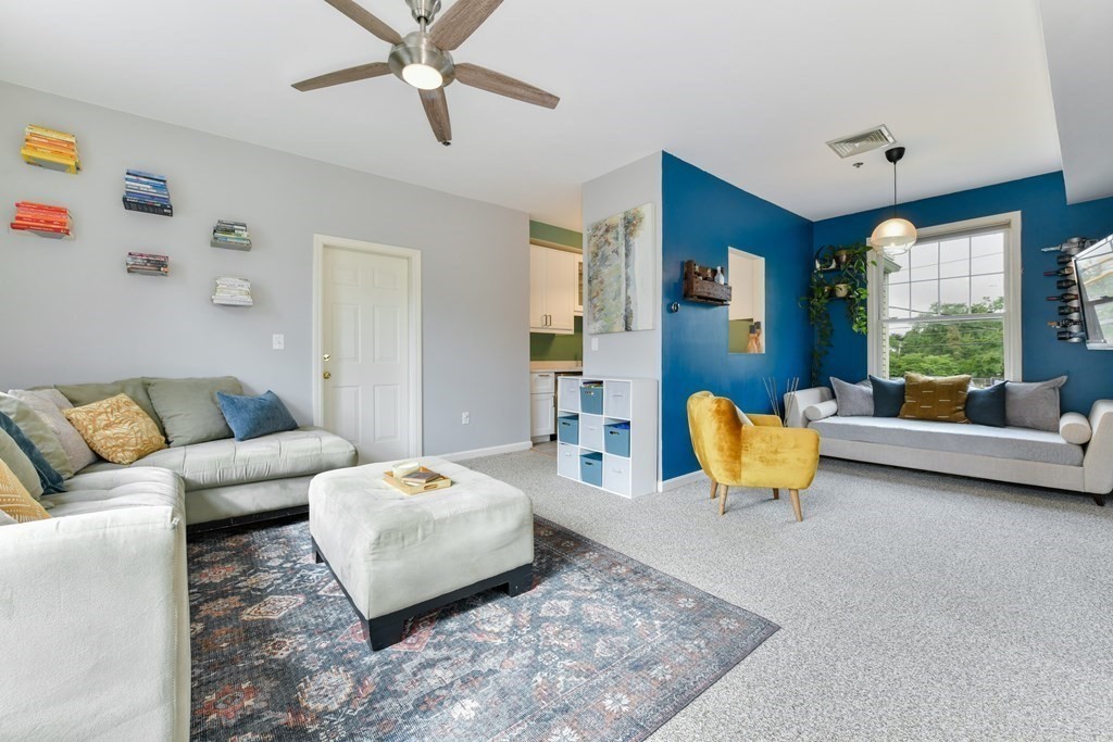 110 Maple Place, Unit 8 Dedham, MA 02026 - Photo 2 of 22 a living room with furniture and a large window
