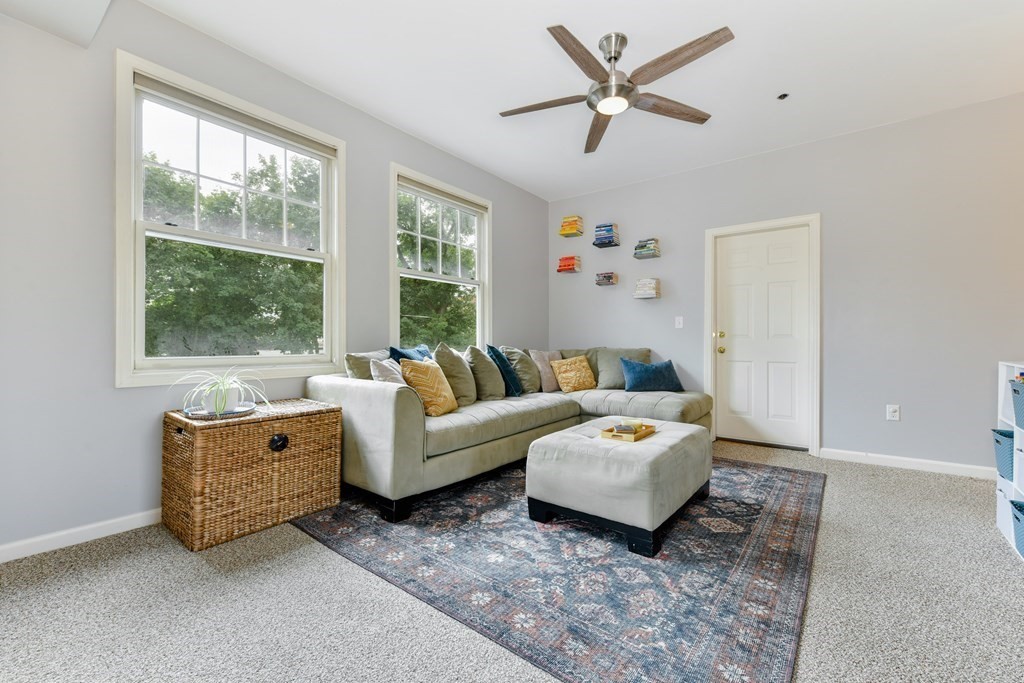 110 Maple Place, Unit 8 Dedham, MA 02026 - Photo 4 of 22 a living room with furniture rug and window