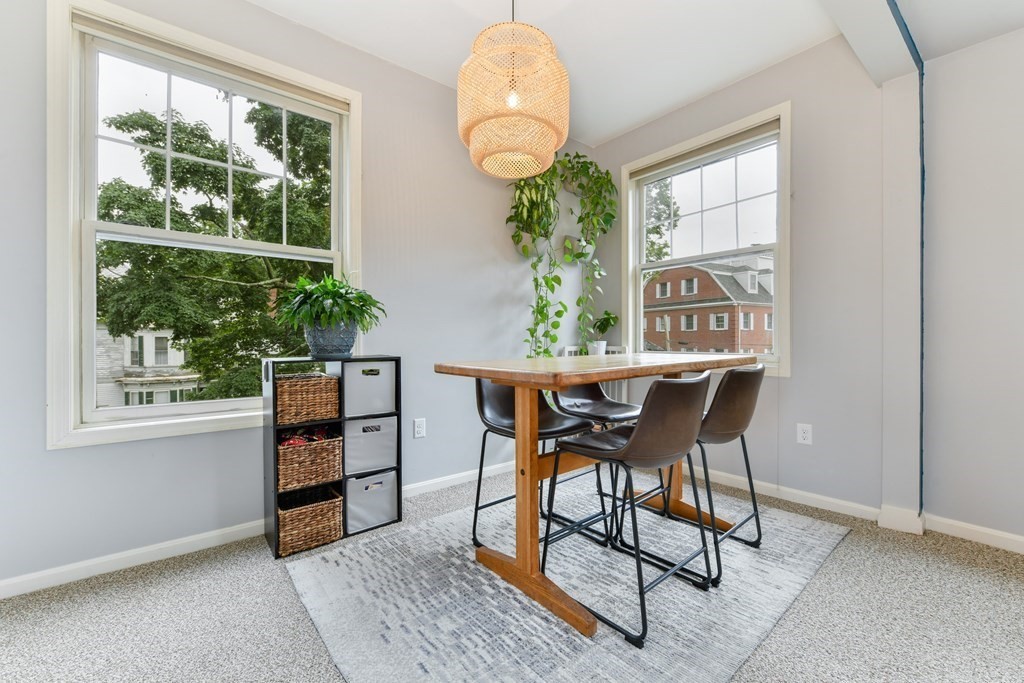 110 Maple Place, Unit 8 Dedham, MA 02026 - Photo 7 of 22 a dining room with furniture and a window