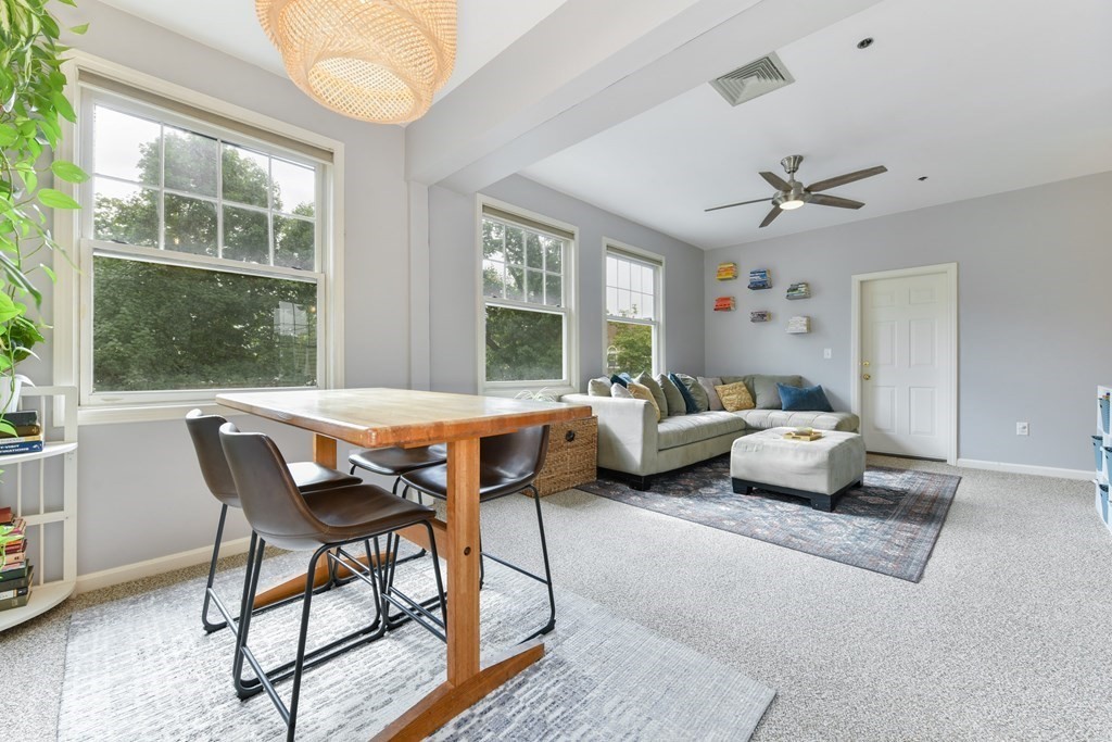 110 Maple Place, Unit 8 Dedham, MA 02026 - Photo 8 of 22 a living room with furniture and a large window