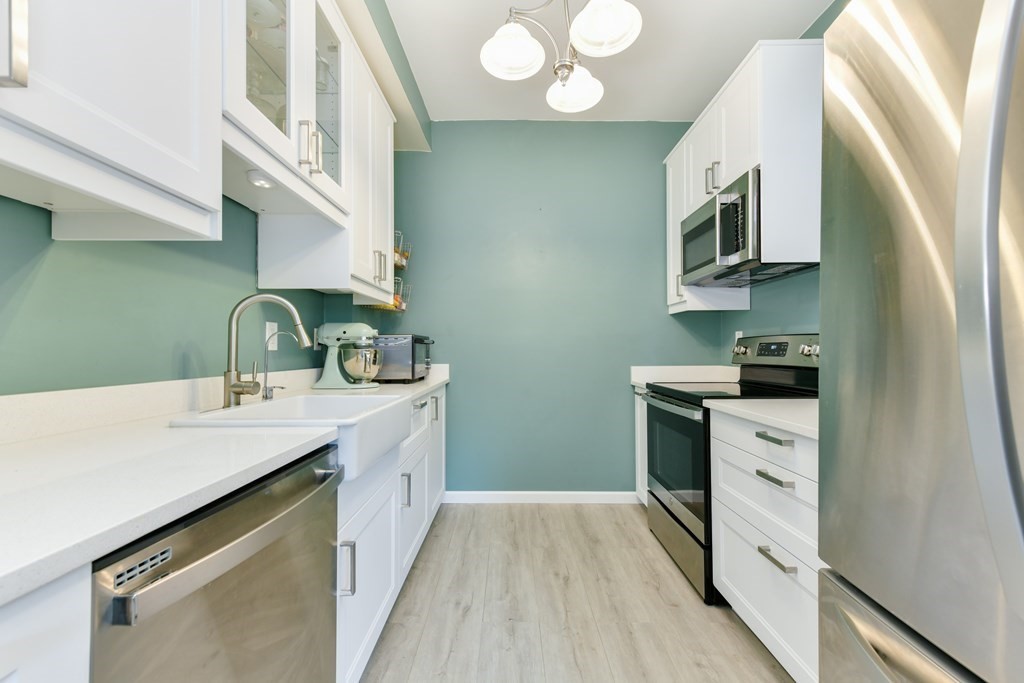 110 Maple Place, Unit 8 Dedham, MA 02026 - Photo 9 of 22 a kitchen with a sink stove and microwave