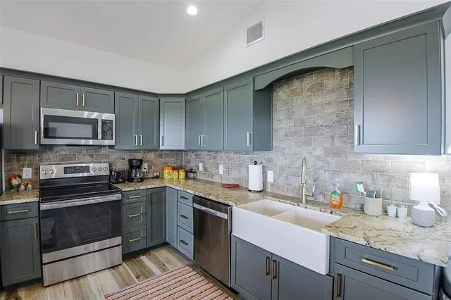 a kitchen with a sink stove and microwave