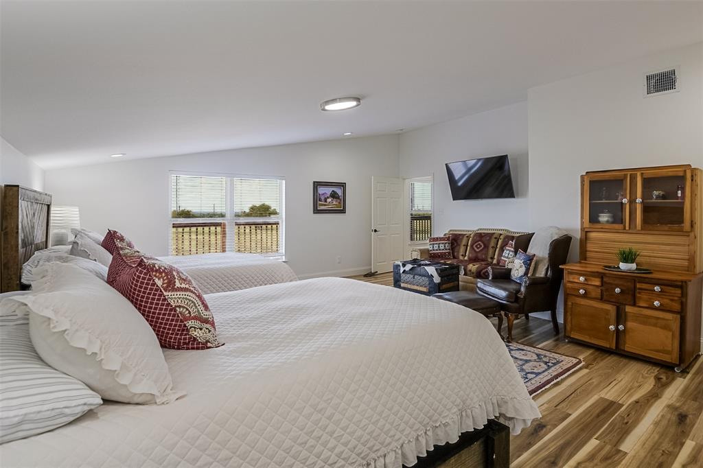 501 A Anderson Rnch Road Waxahachie, TX 75167 - Photo 20 of 36 a bedroom with a bed and wooden floor