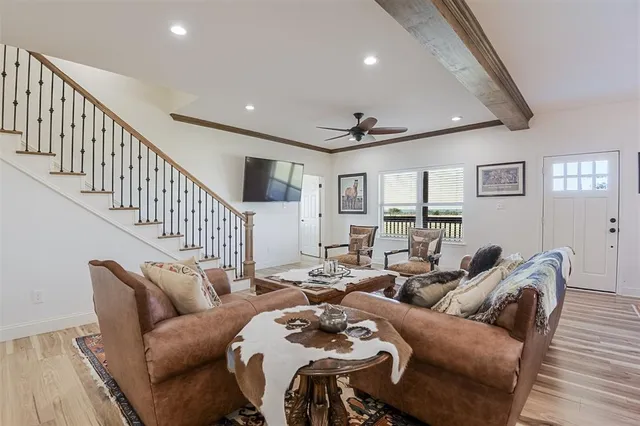 a living room with furniture and wooden floor