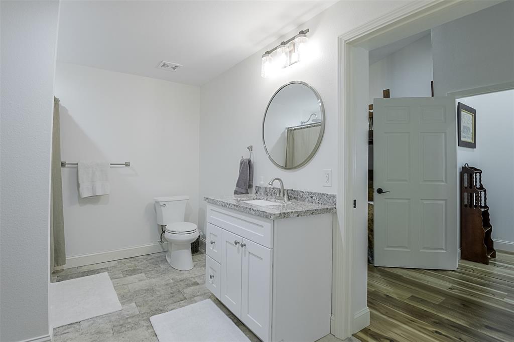 501 A Anderson Rnch Road Waxahachie, TX 75167 - Photo 21 of 36 a bathroom with a toilet a sink and a mirror