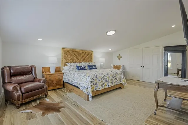 a bedroom with a bed and couch