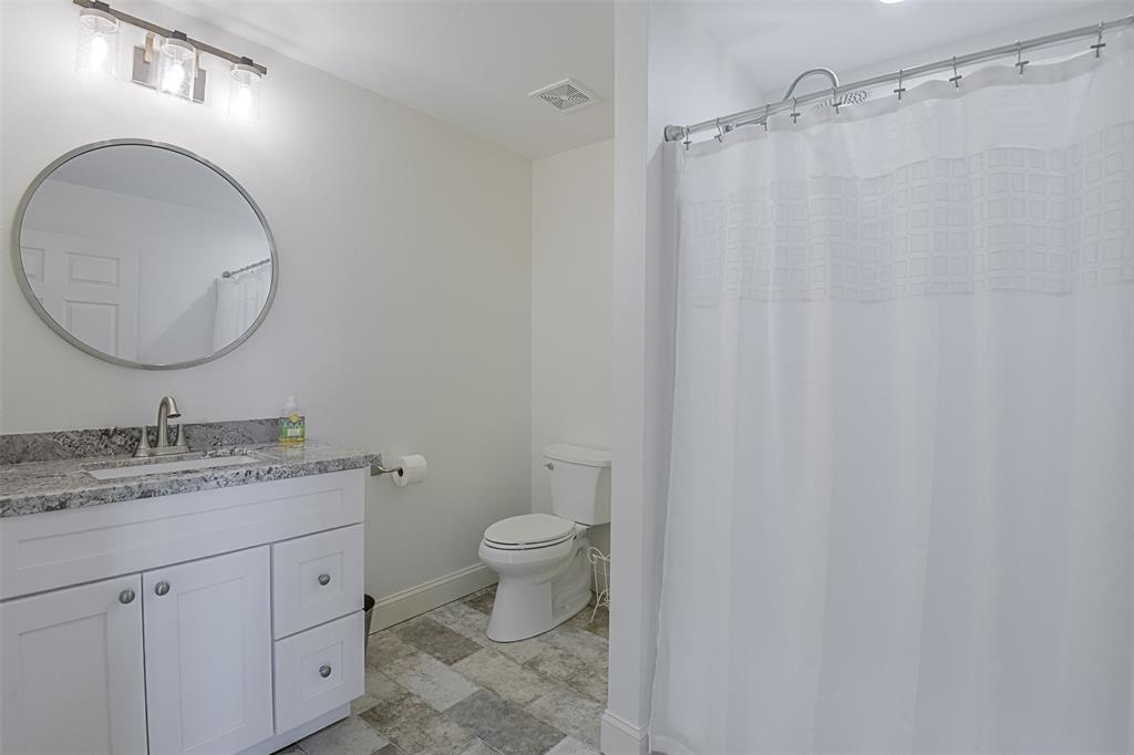 501 A Anderson Rnch Road Waxahachie, TX 75167 - Photo 23 of 36 a bathroom with a granite countertop sink toilet and a mirror