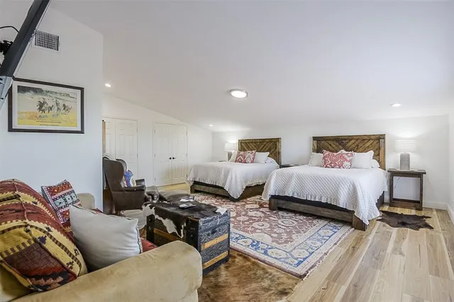 a bed room with two bed and a couch