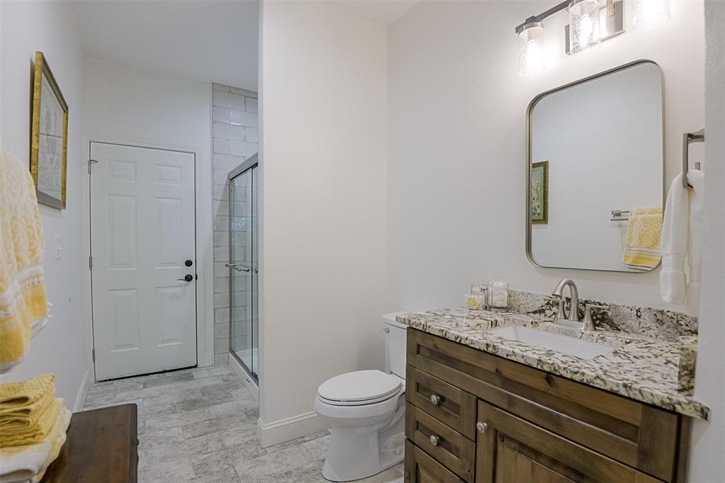 501 A Anderson Rnch Road Waxahachie, TX 75167 - Photo 25 of 36 a bathroom with a granite countertop toilet sink and mirror