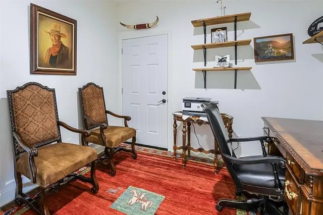 a view of a workspace with furniture and wooden floor