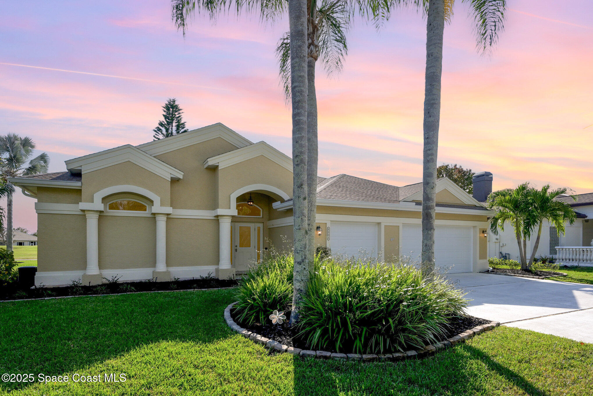 a front view of a house with a garden