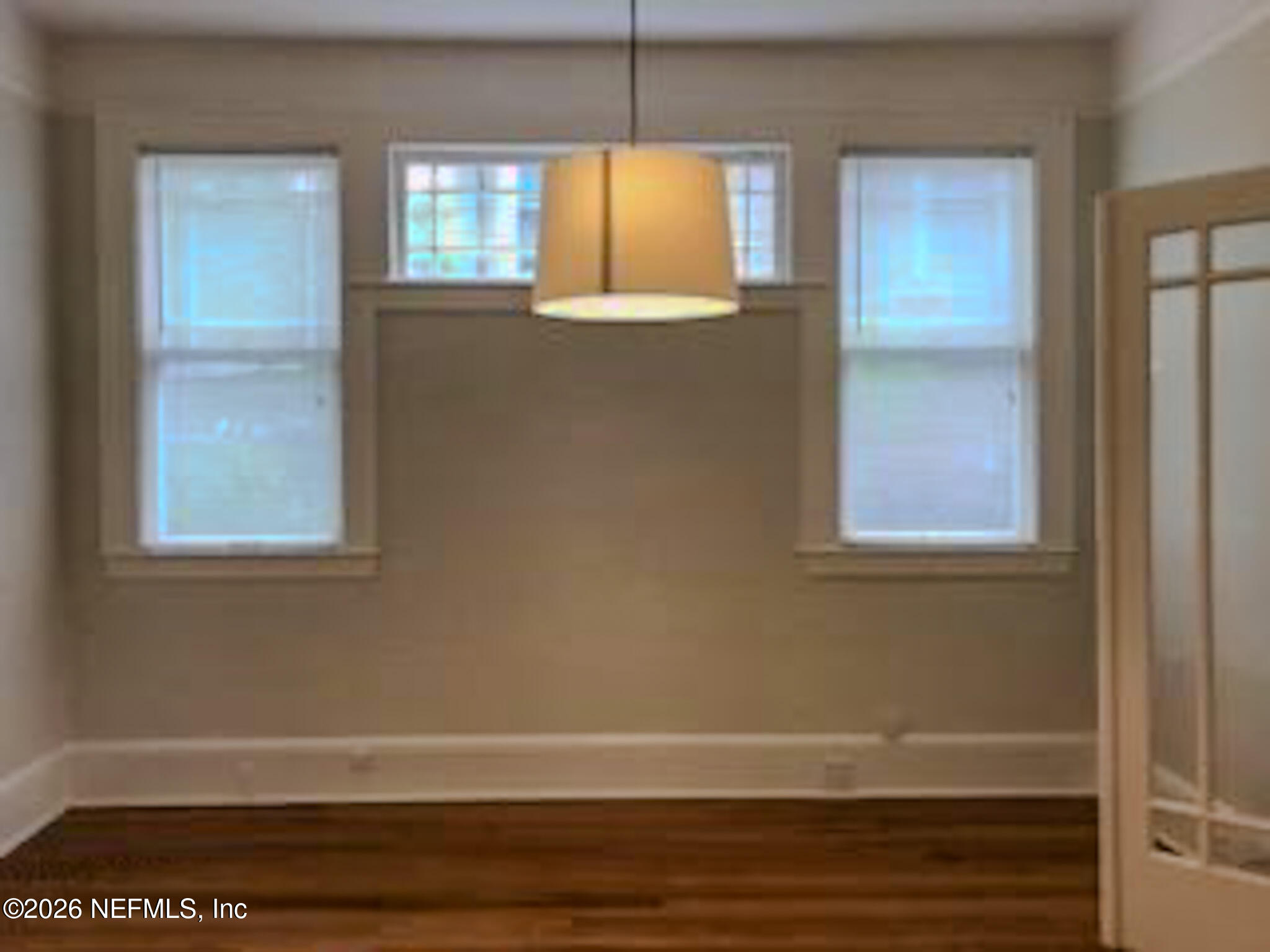 3664 Riverside Avenue Jacksonville, FL 32205 - Photo 7 of 19 a view of an empty room with window and wooden floor