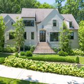 a front view of a house with a garden