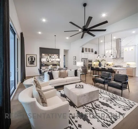 a living room with fireplace furniture and a rug