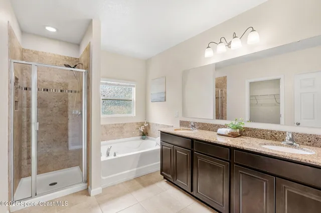 a bathroom with a granite countertop sink mirror and shower
