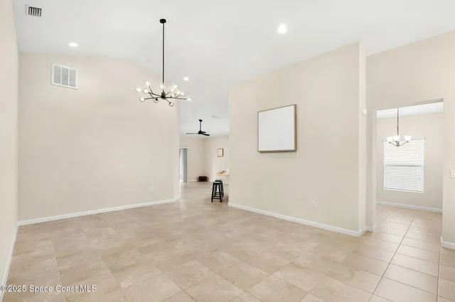 a view of a room with wooden floor and a ceiling fan