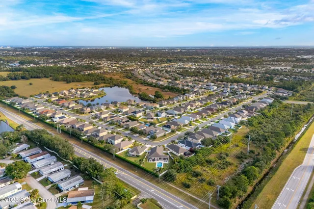 an aerial view of residential building with parking