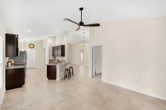 a view of a livingroom with kitchen appliances and furniture