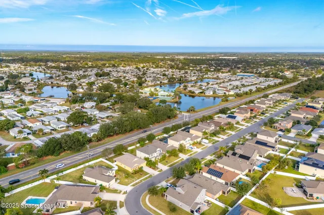 aerial view of a house with swimming pool and porch