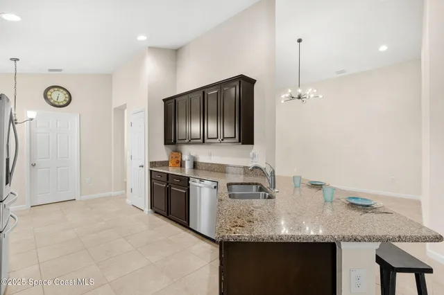 a kitchen with granite countertop a sink stainless steel appliances and cabinets