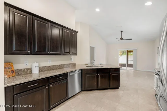 a kitchen with stainless steel appliances granite countertop a sink and cabinets