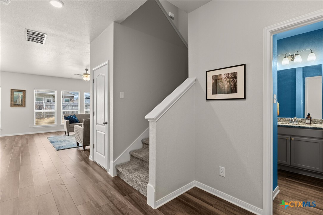 2233 Chia Court Temple, TX 76501 - Photo 20 of 47 a view of a hallway with wooden floor and staircase