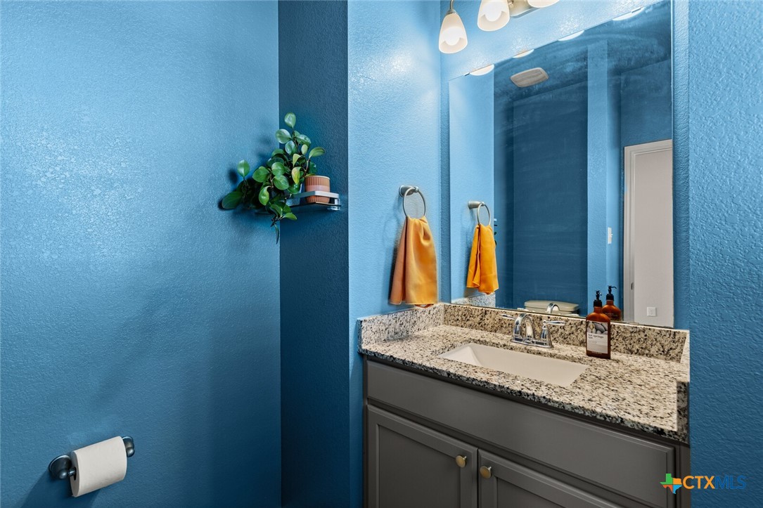2233 Chia Court Temple, TX 76501 - Photo 21 of 47 a bathroom with a granite countertop sink and a mirror