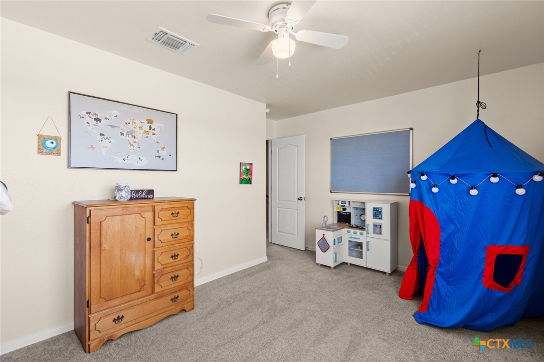 2233 Chia Court Temple, TX 76501 - Photo 25 of 47 a bedroom with a bed and a chandelier