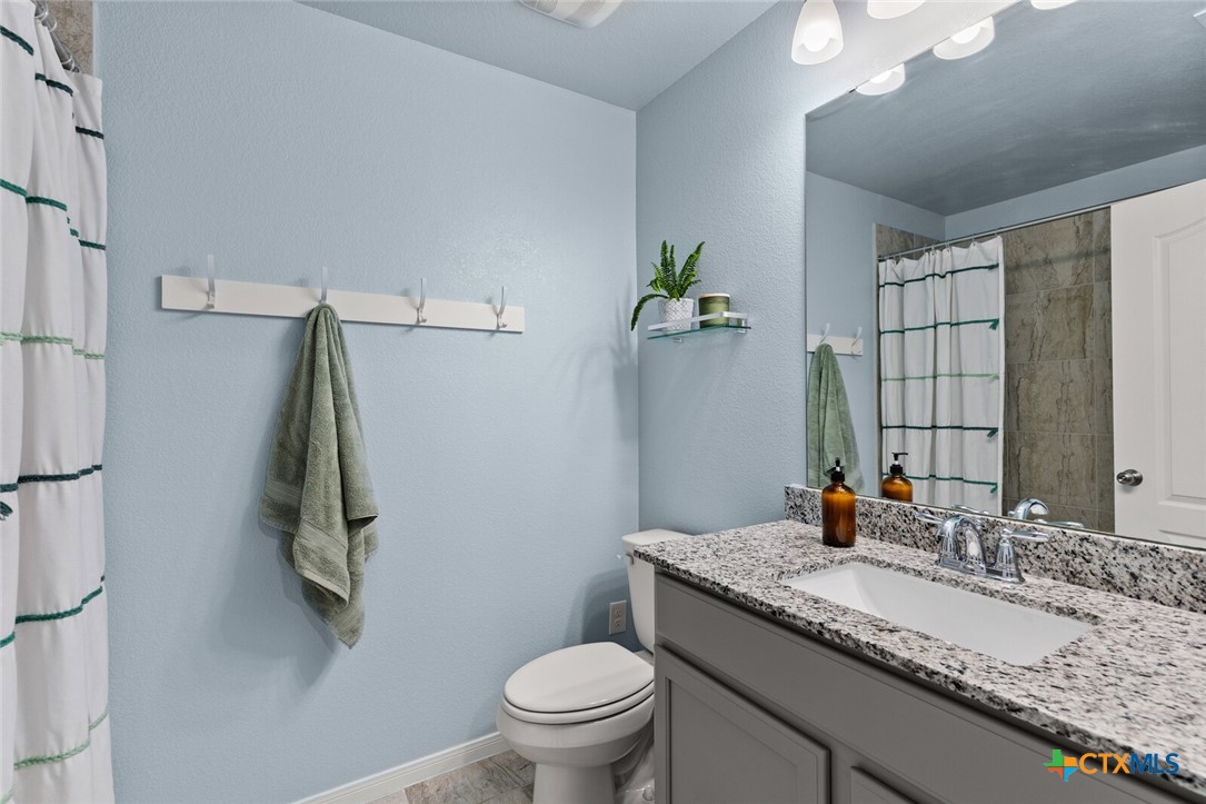 2233 Chia Court Temple, TX 76501 - Photo 26 of 47 a bathroom with a granite countertop sink and a mirror