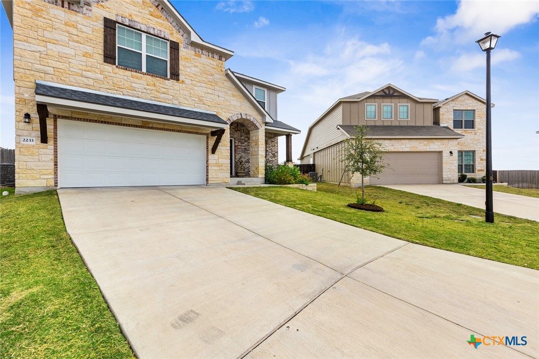 2233 Chia Court Temple, TX 76501 - Photo 3 of 47 a front view of a house with a yard and garage