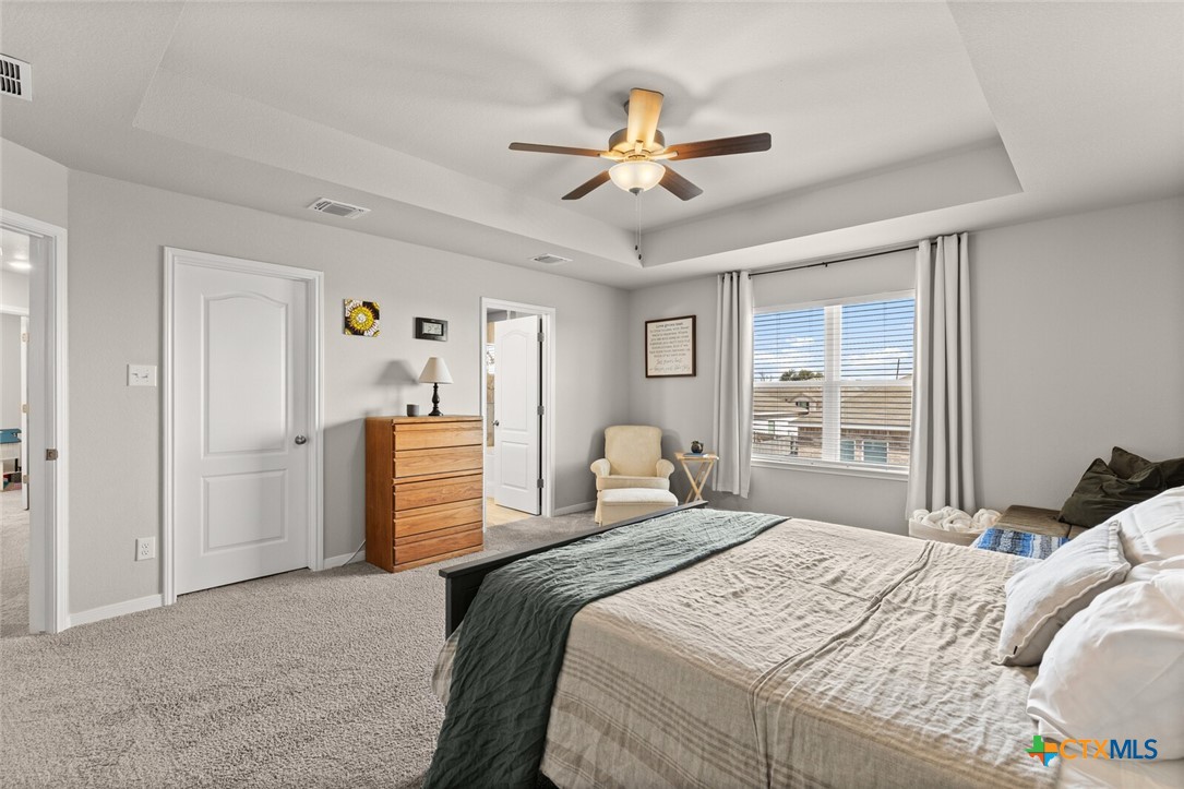 2233 Chia Court Temple, TX 76501 - Photo 32 of 47 a bedroom with a bed and a chandelier
